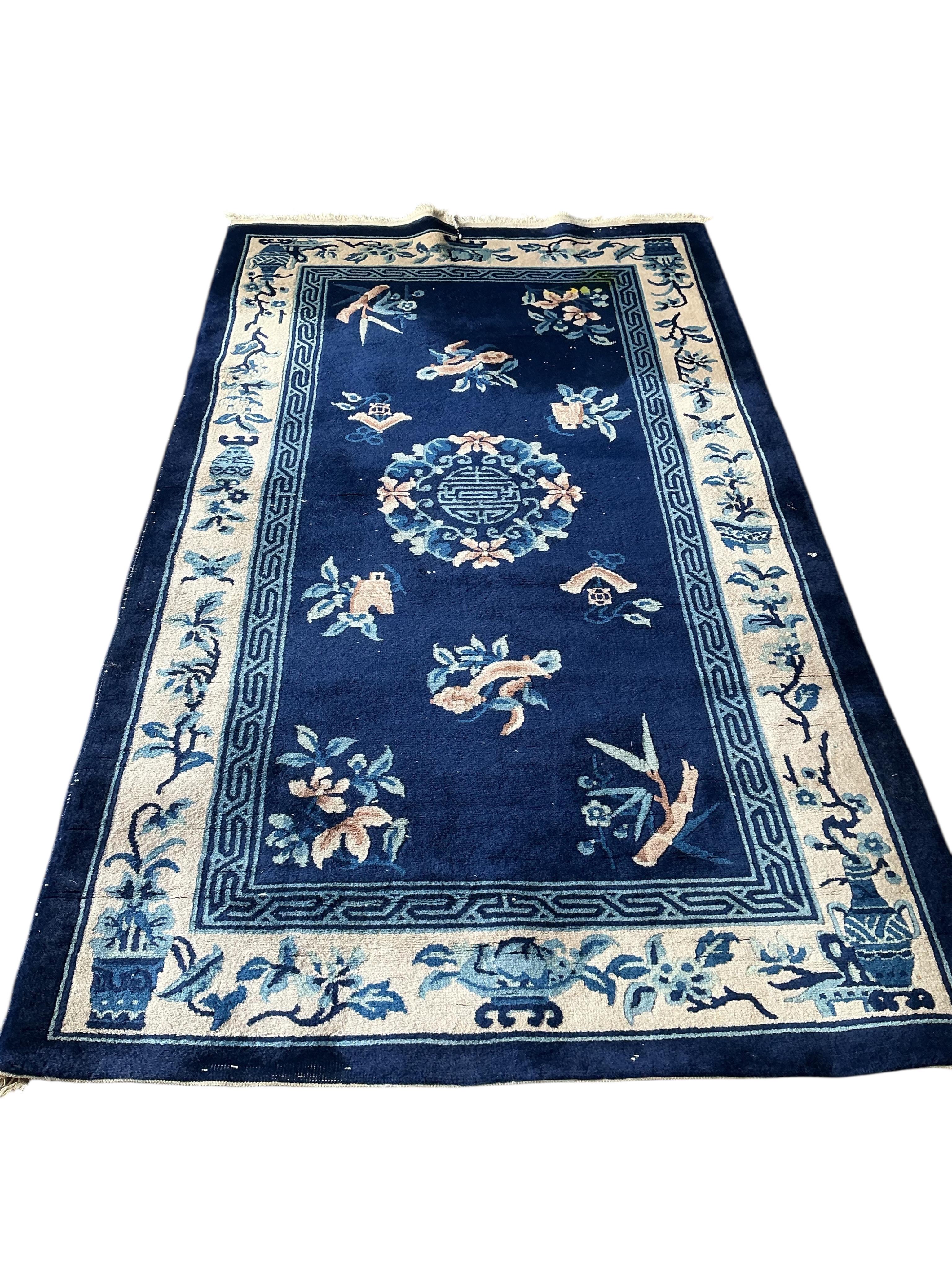 A Chinese blue ground rug, 210 x 124cm